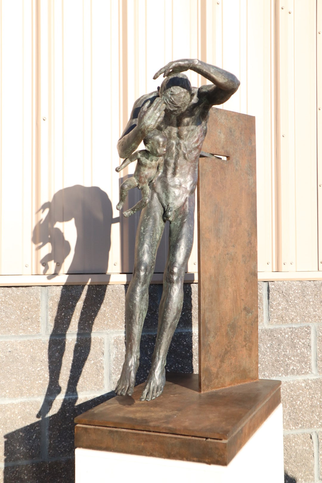 TREVOR SOUTHEY BRONZE SCULPTURE, "FATHERHOOD", DEPICTION OF MAN WITH INFANT, BRONZE AND STEEL, WITH BASE